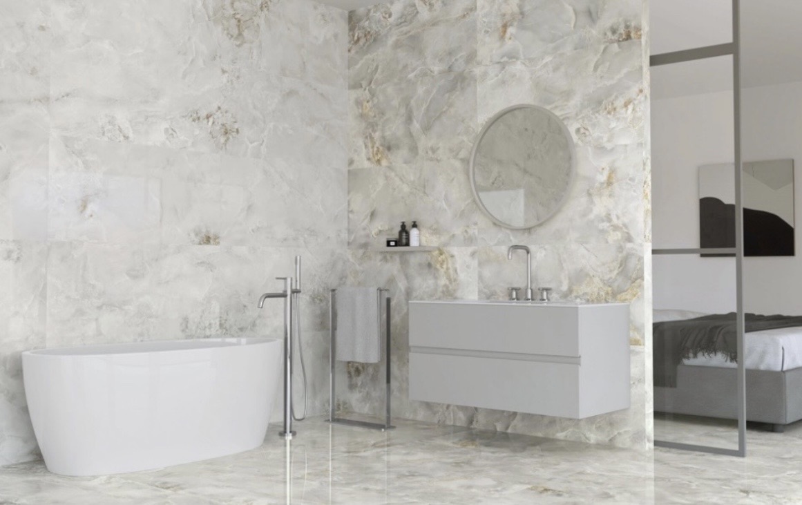 Modern luxury bathroom with large-format polished stone tiles, freestanding bathtub and floating vanity