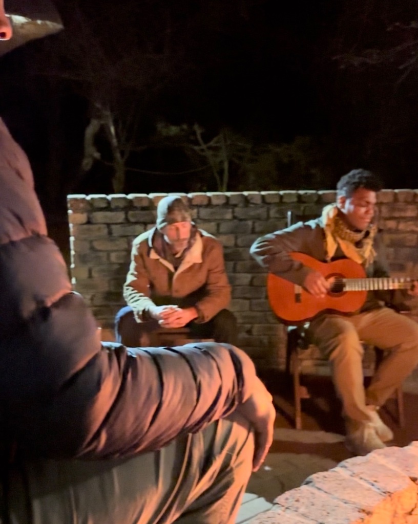 Veterans at the campfire with guitar