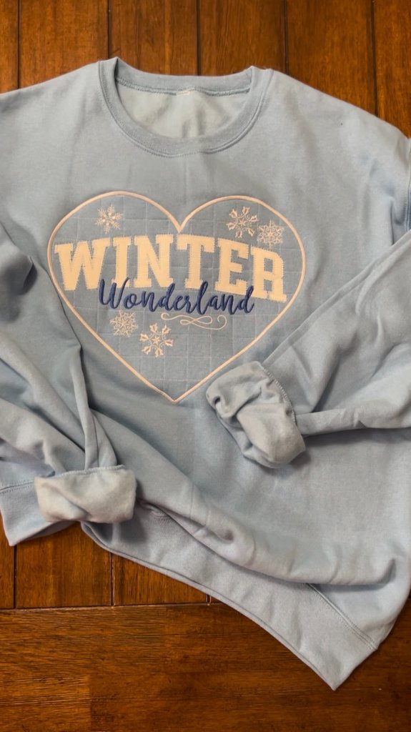 Winter Wonderland design on a light blue sweatshirt produced by Sew Suite