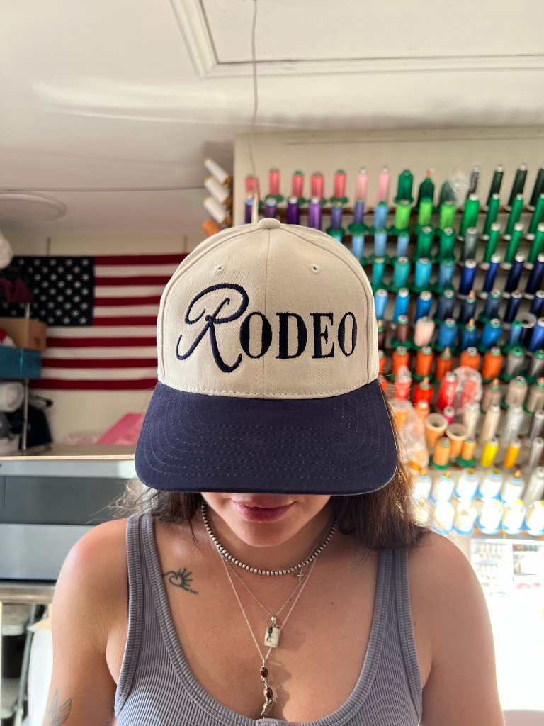 Rodeo lettering embroidered on a two-tone cap by Sew Suite