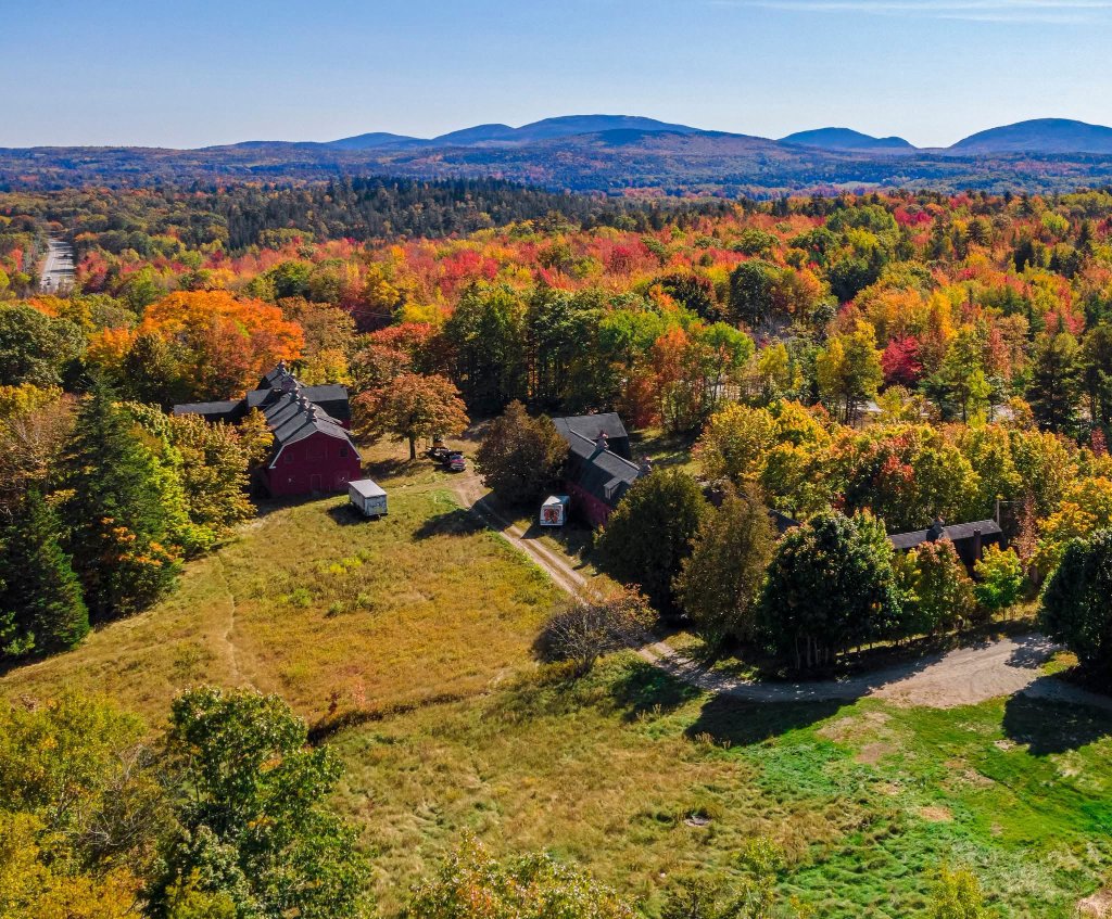 Aerial view of Hamilton Station site showing existing barn structures and fall foliage