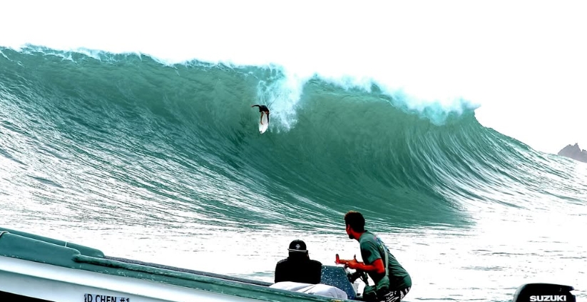 Watching a surfer aerial off a big wave from the boat