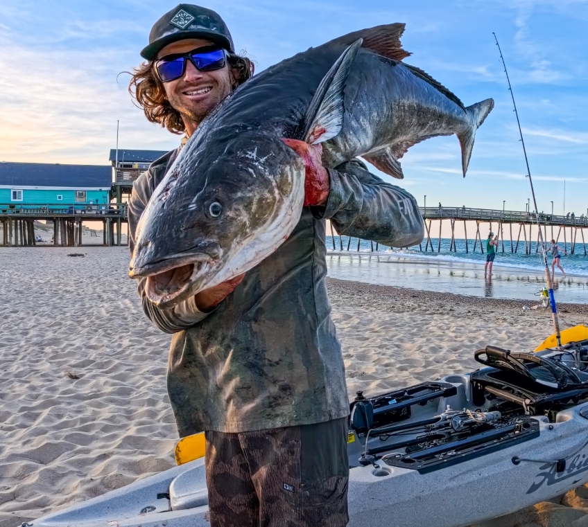 Quentin Turko holding a large fish on an Outer Banks beach
