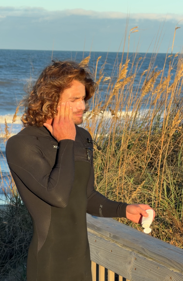Quentin Turko applying True Coast sunscreen at sunset on the Outer Banks
