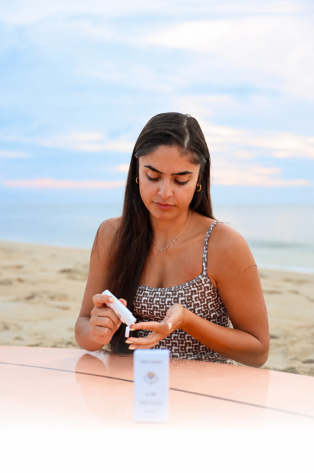 Applying True Coast sunscreen on the beach