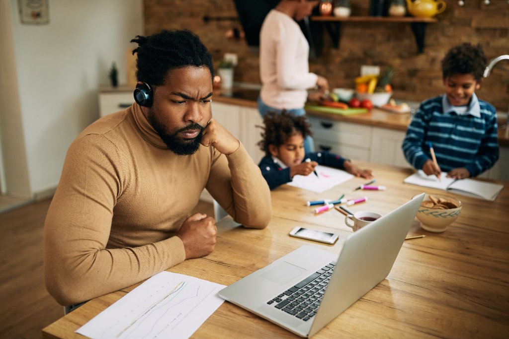 Adult student studying at home with family