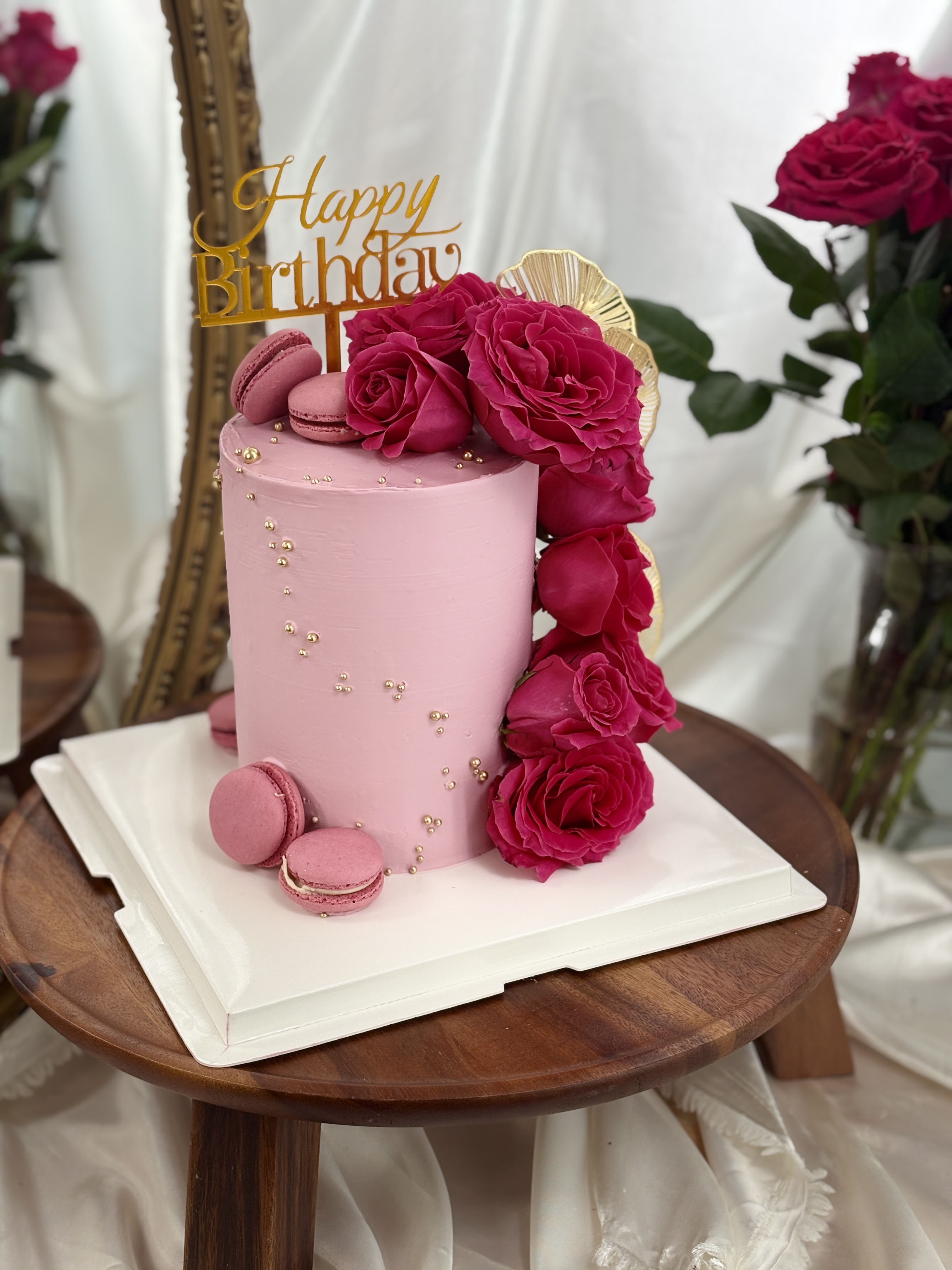 Gâteau anniversaire rose "Happy Birthday" roses fuchsia macarons et perles dorées — Délices Éthérés