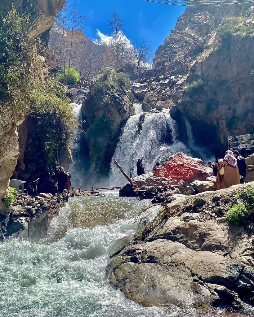 Travellers at a waterfall near Imlil in the High Atlas Mountains