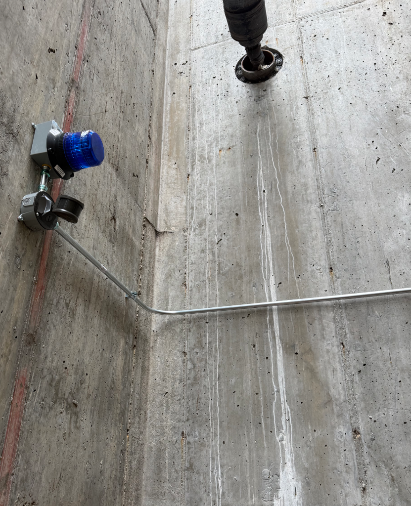 Security lighting fixture installation on concrete wall