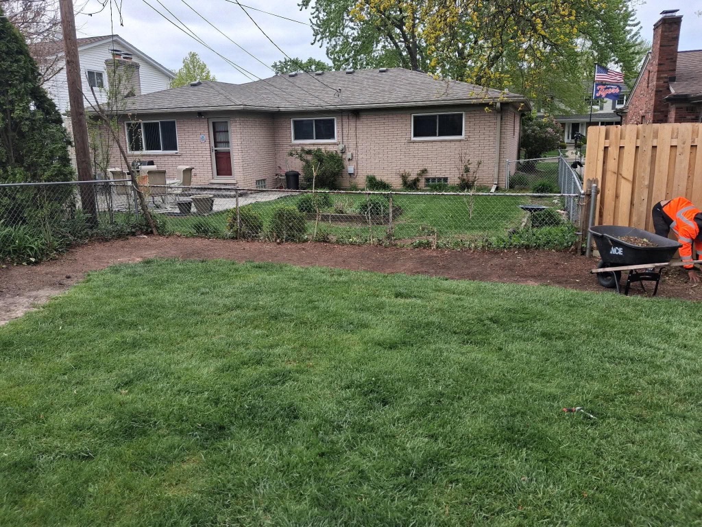 Landscaping soil work along the back fence line