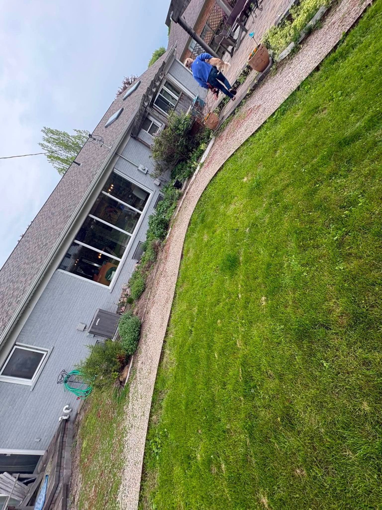 Clean pebble path alongside brick home