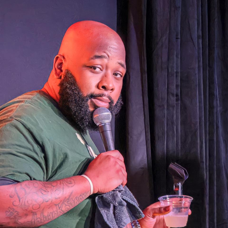 BigBaby Green performing on stage with a mic