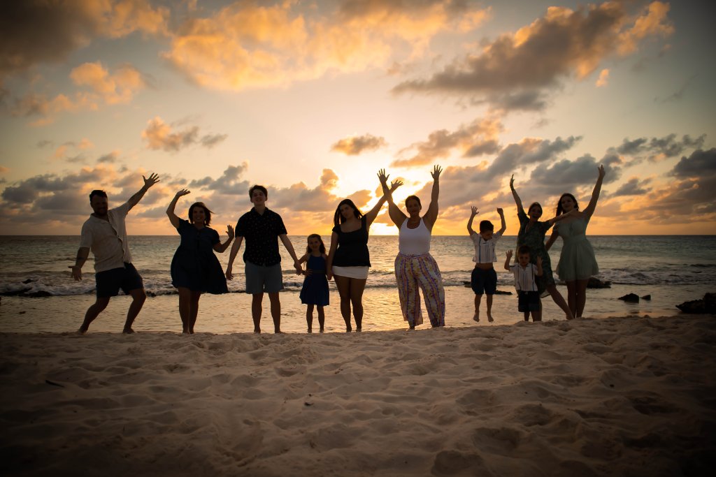 Family celebrating at sunset on Bonaire beach