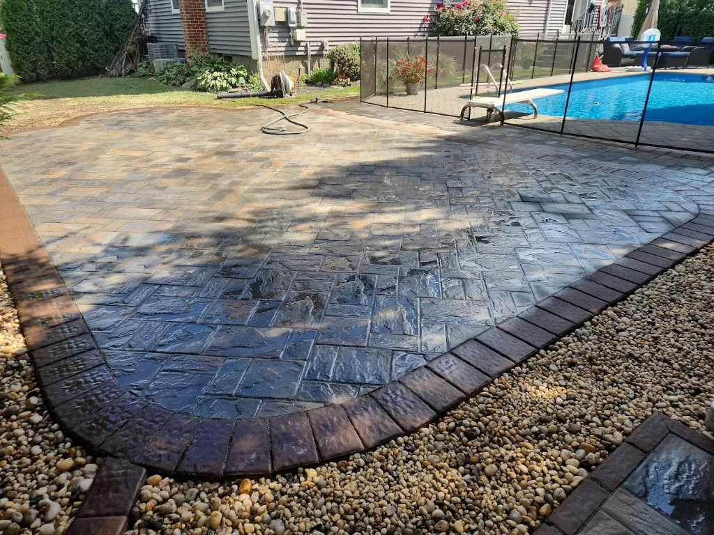 Bueno Landscaping — stamped concrete patio with pool surround