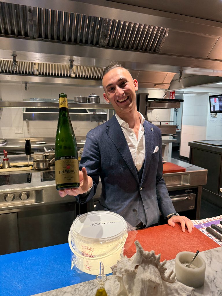 Jakub in restaurant kitchen with Trimbach Riesling