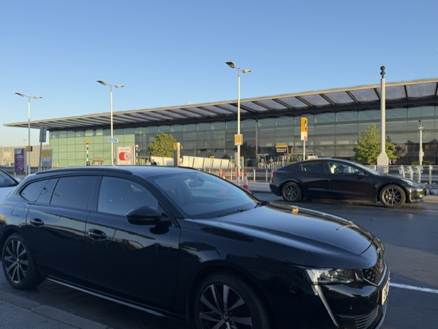 Deb's car parked outside a Heathrow terminal