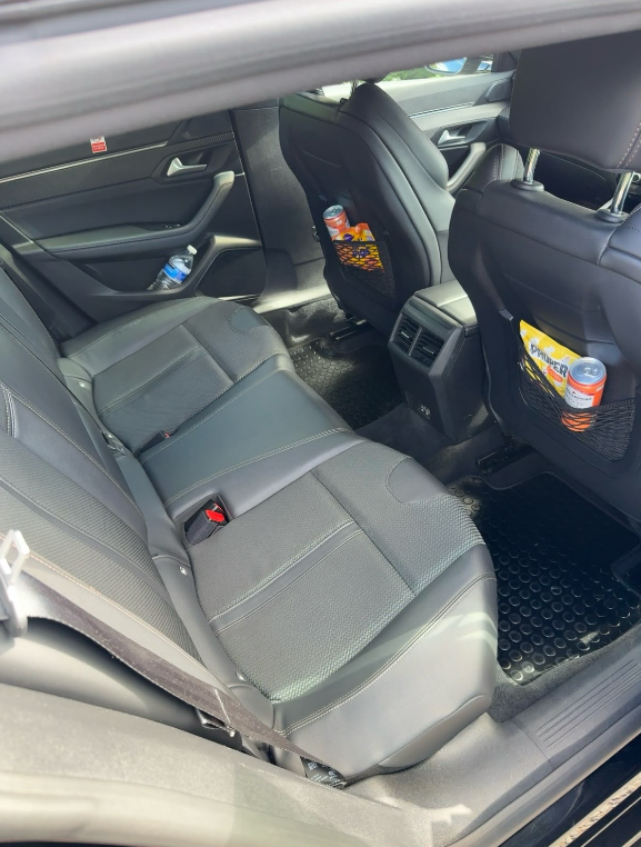 Interior of Deb's car with water, charging and snacks for passengers