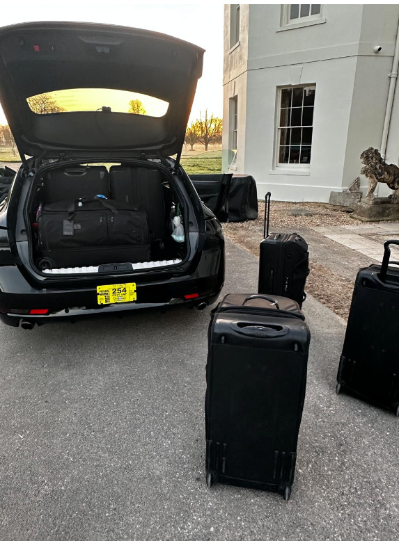 Deb's car parked at a customer's home at dusk