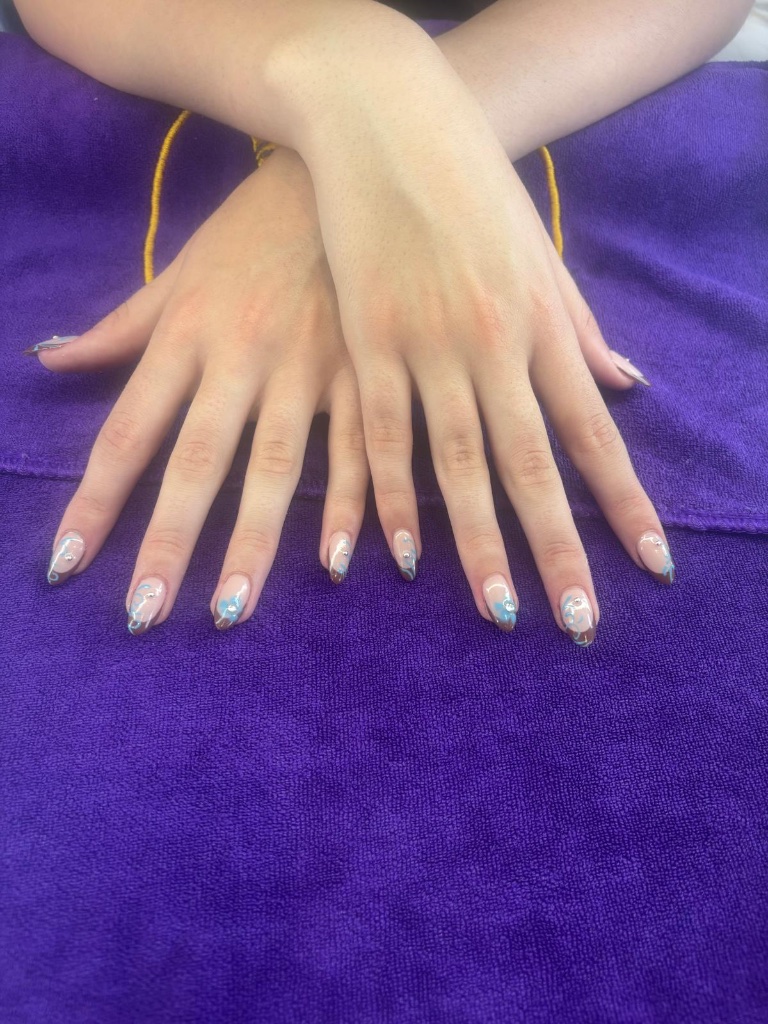 French tip with blue swirls and rhinestones