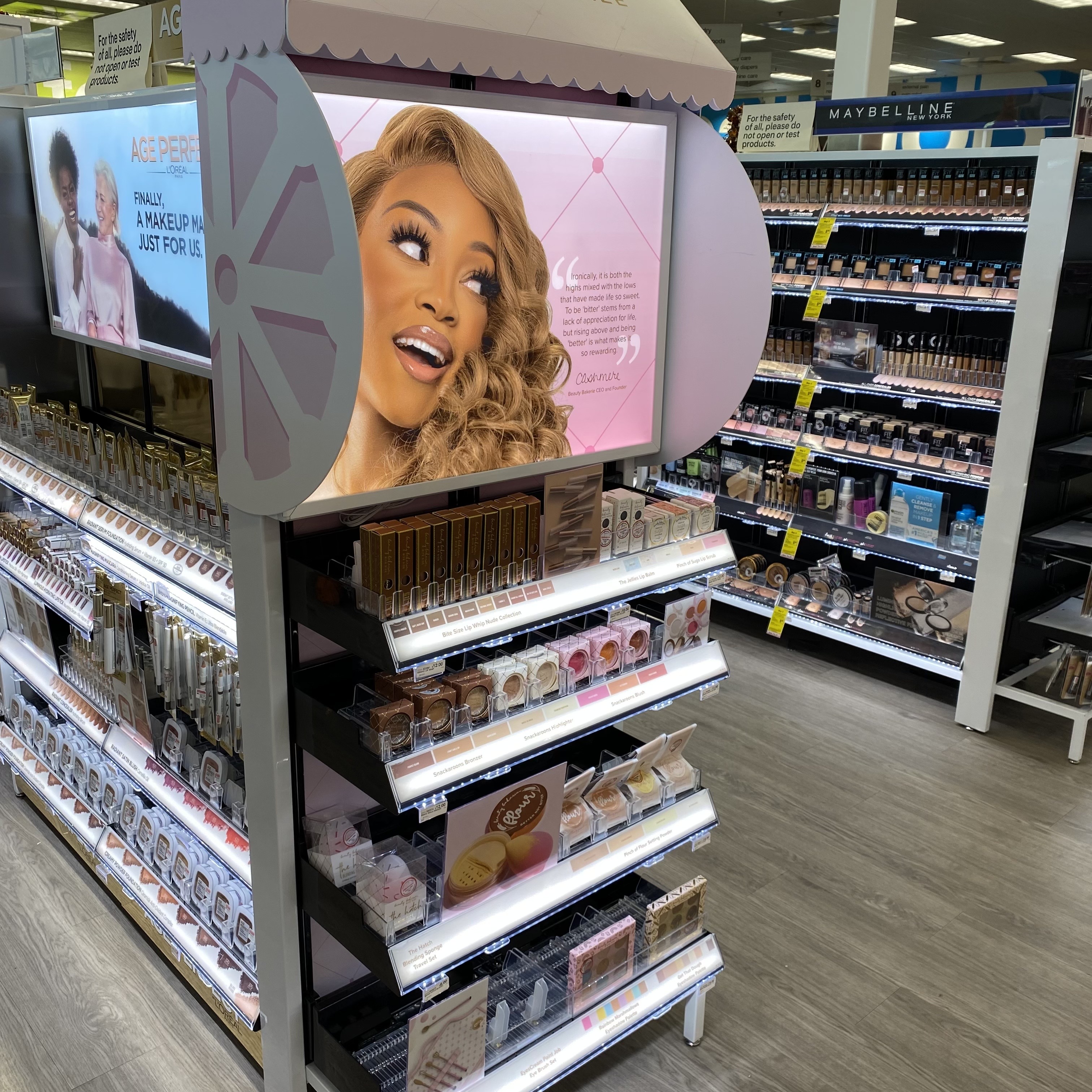 Beauty Bakerie end-cap display with founder signage in a drugstore aisle
