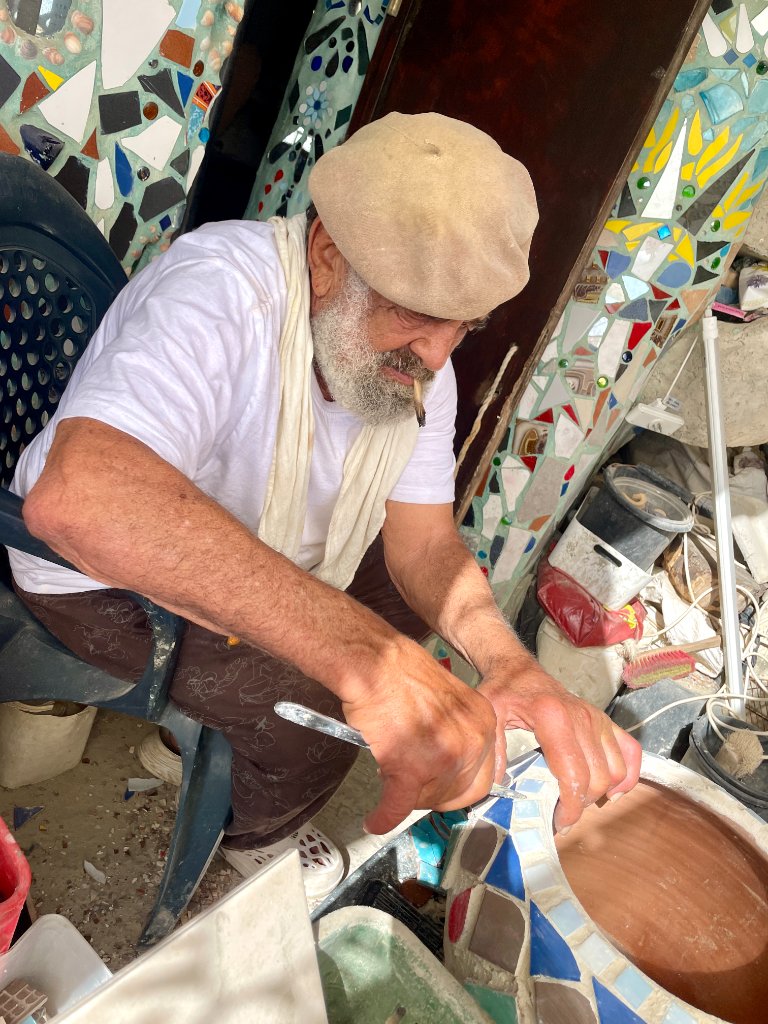 Nissim Kahlon working on his cliff-side creation