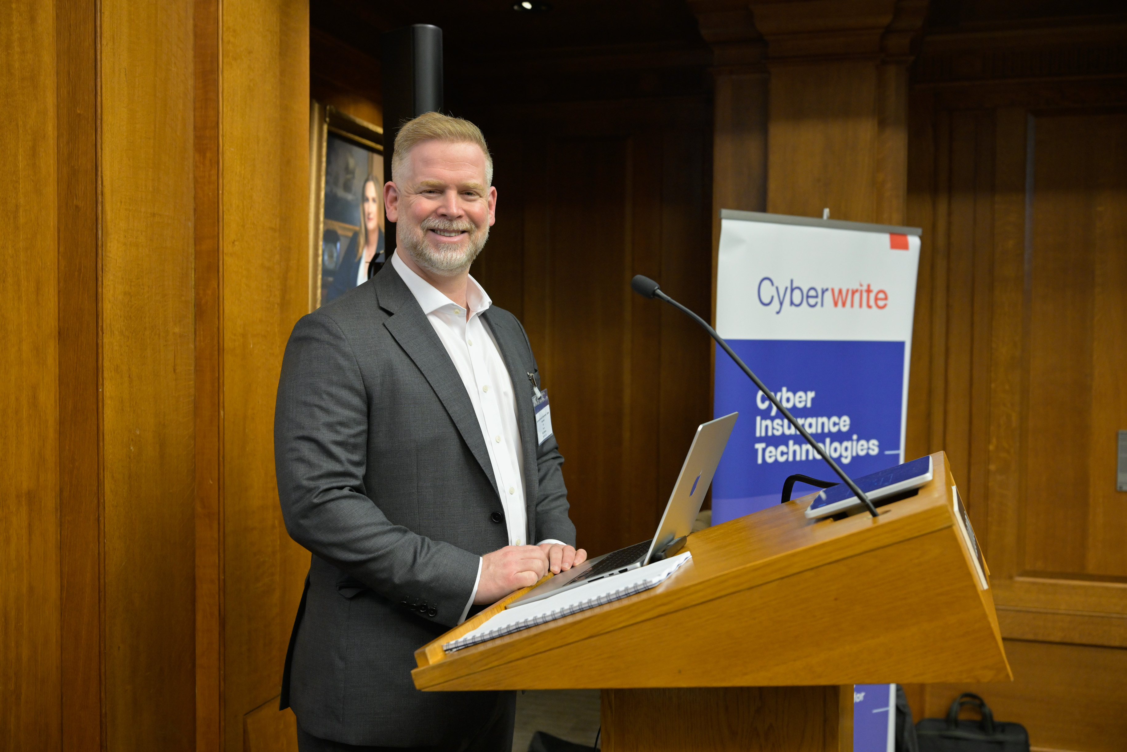 A speaker at the podium in the Lloyd's Old Library.