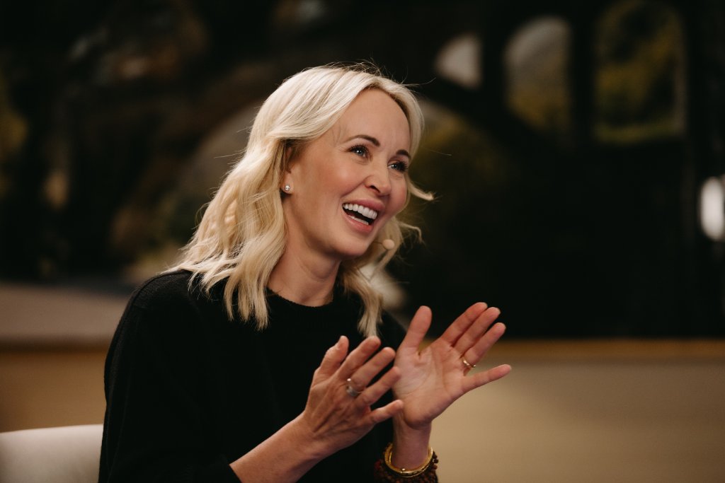 Woman laughing during a studio conversation