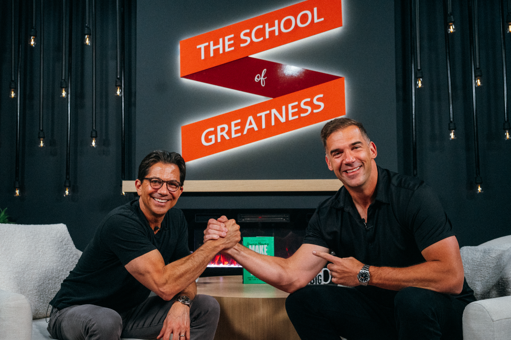 Two figures shaking hands in a studio