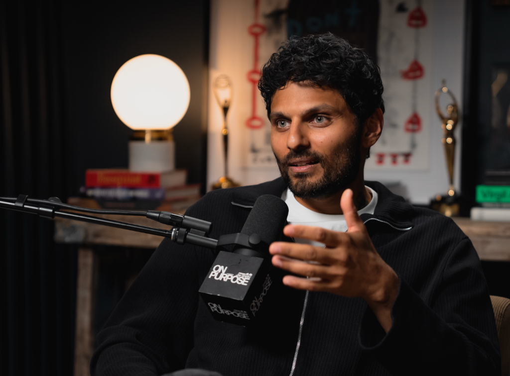Man speaking into a studio microphone with an On Purpose windscreen