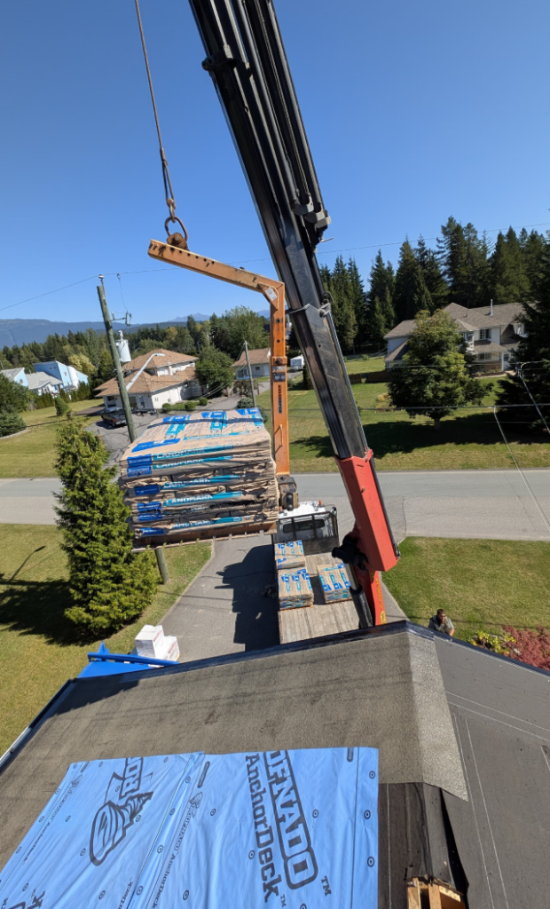Shingles Being Crane-Lifted to Roof