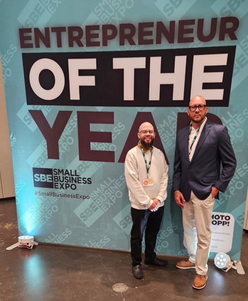 NJTECHLAND LLC team at Small Business Expo NYC Spring 2026 Entrepreneur of the Year backdrop connecting with business community