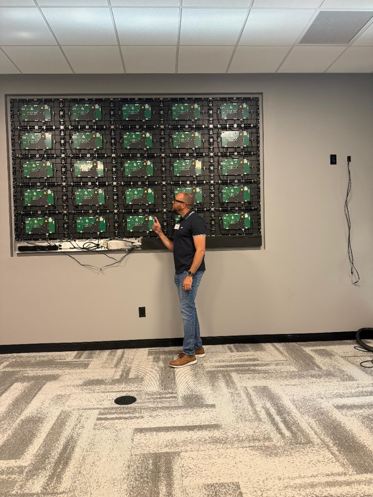 NJTECHLAND technician assembling a ViewSonic Direct View LED wall during hands-on certification training