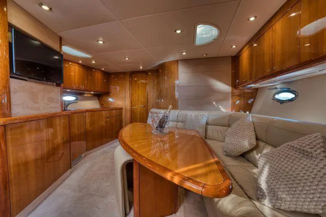 Dated 1990s yacht cabin with worn teak paneling and old fixtures
