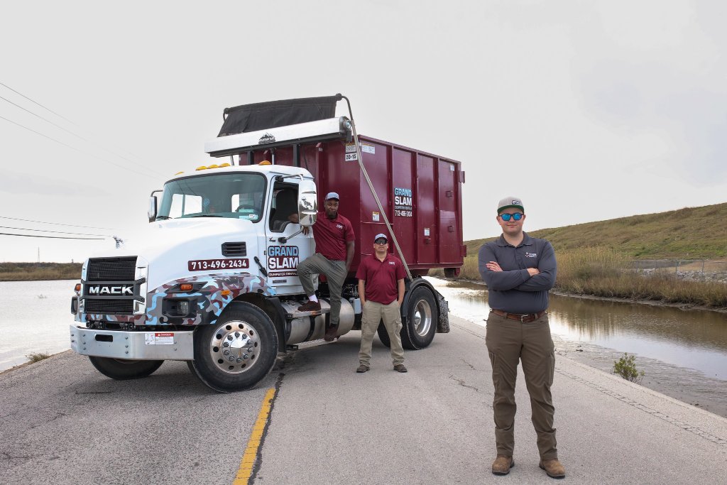The Grand Slam team with their dumpster delivery truck near Houston and Katy
