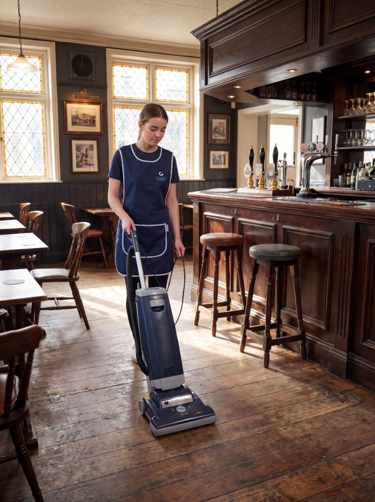 Cynergy cleaner vacuuming floors during a property clean