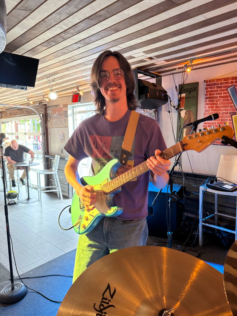 Guitarist smiling at venue