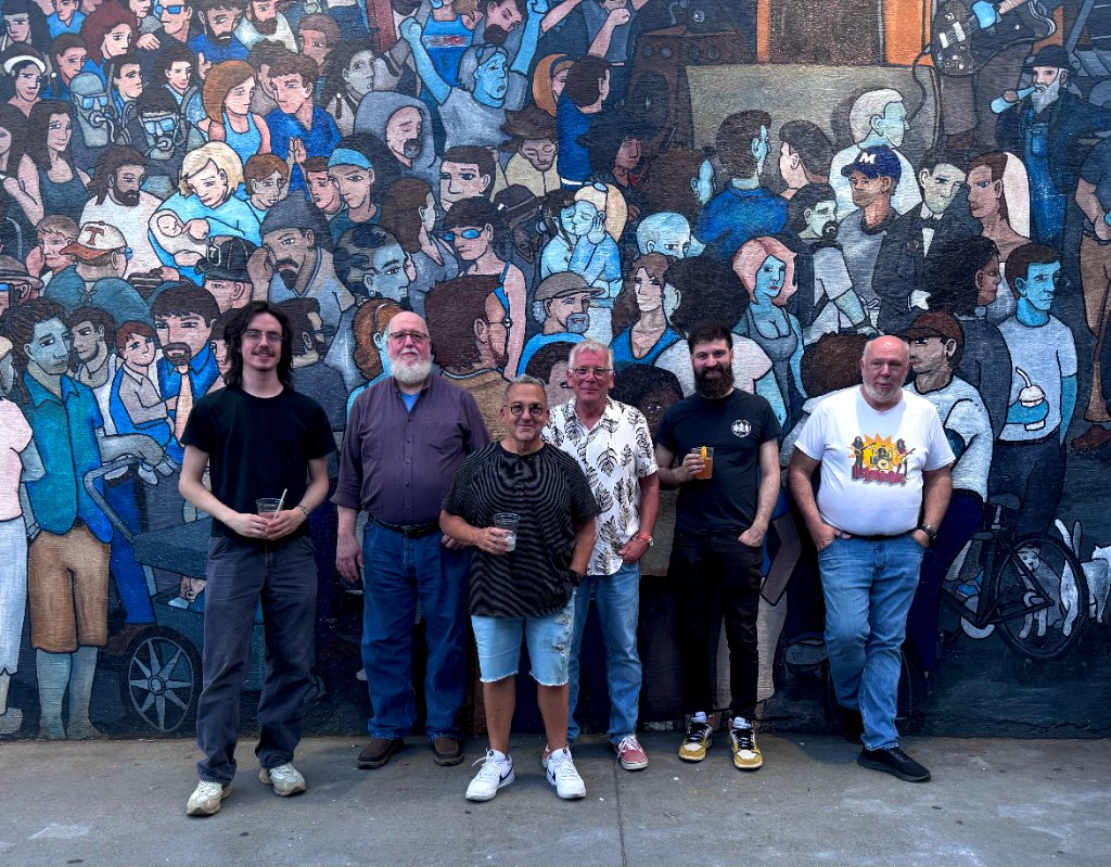 Full band photo at mural