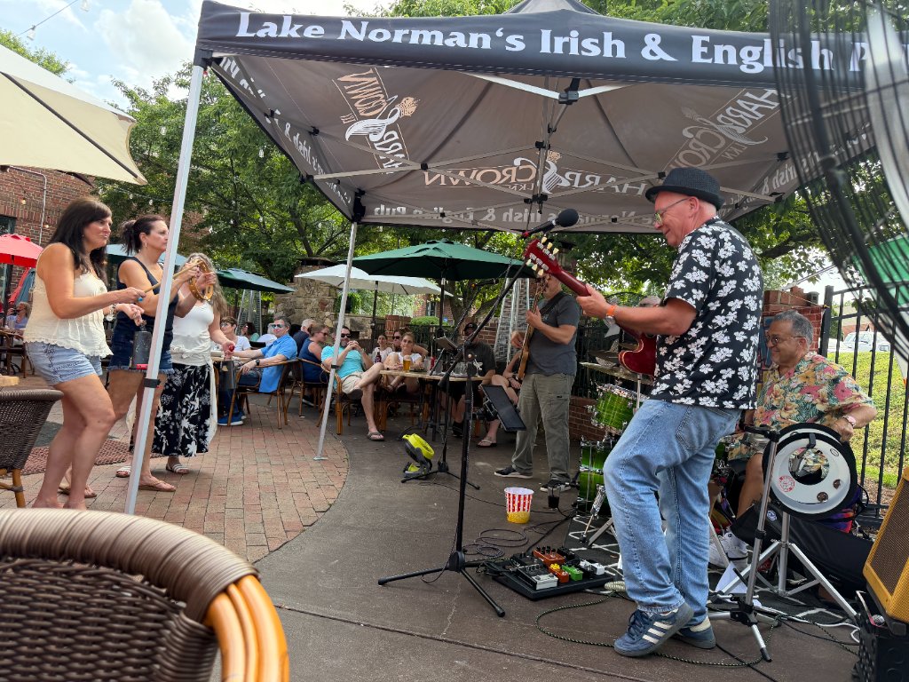 Guitarist performing outdoor show at Harp and Crown