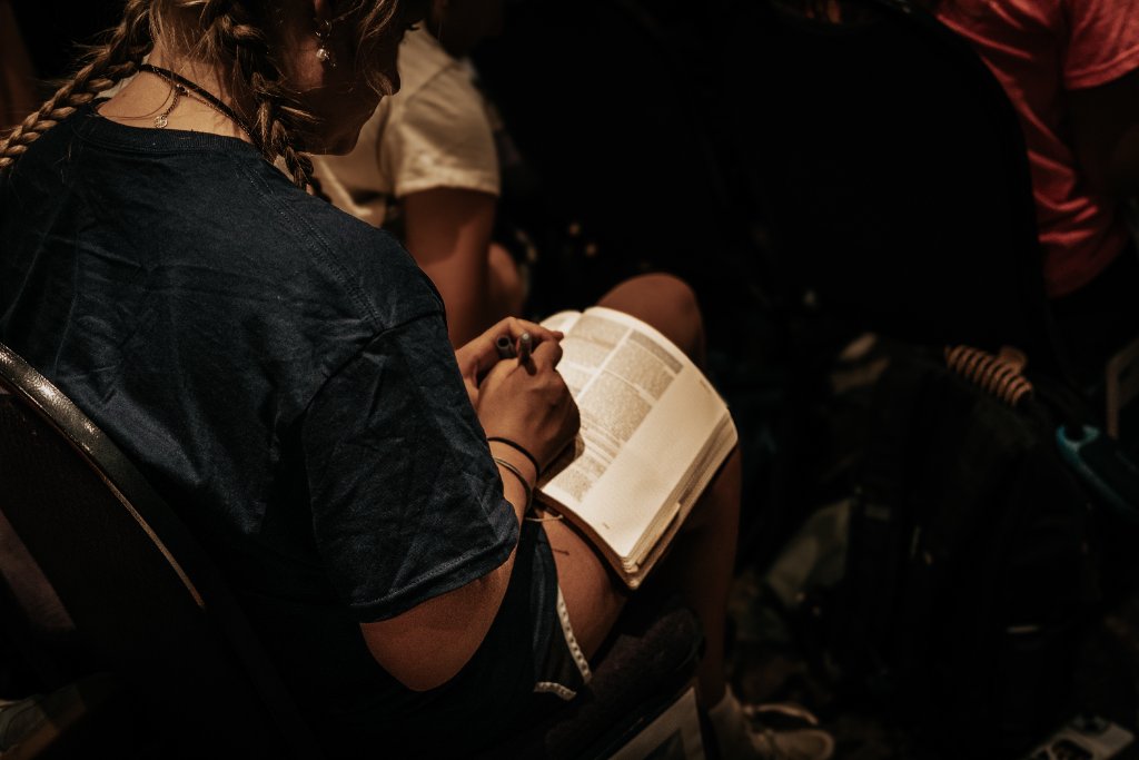 Student reading and marking Bible at FUGE Camps