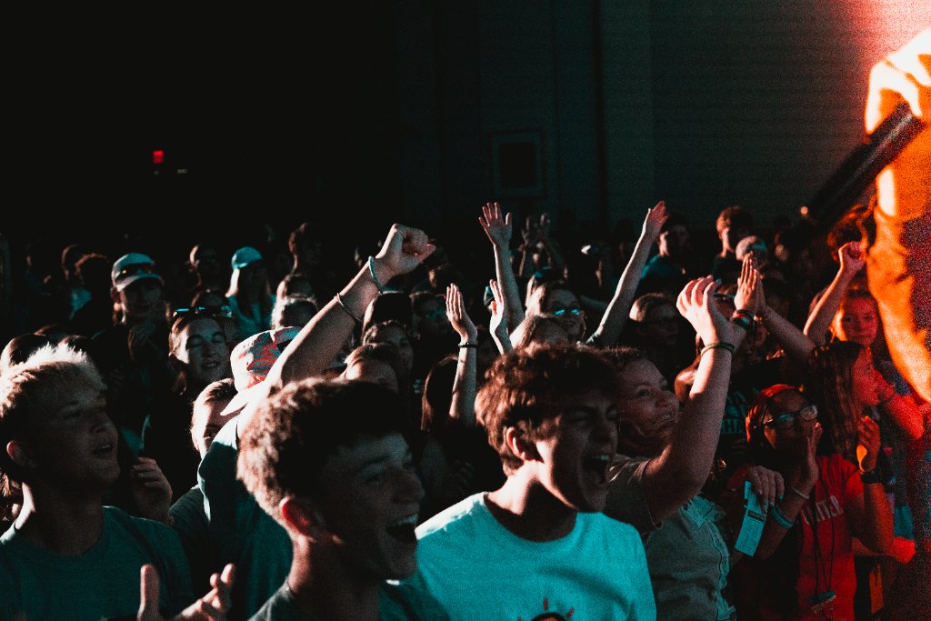 Students with hands raised in worship at FUGE Camps