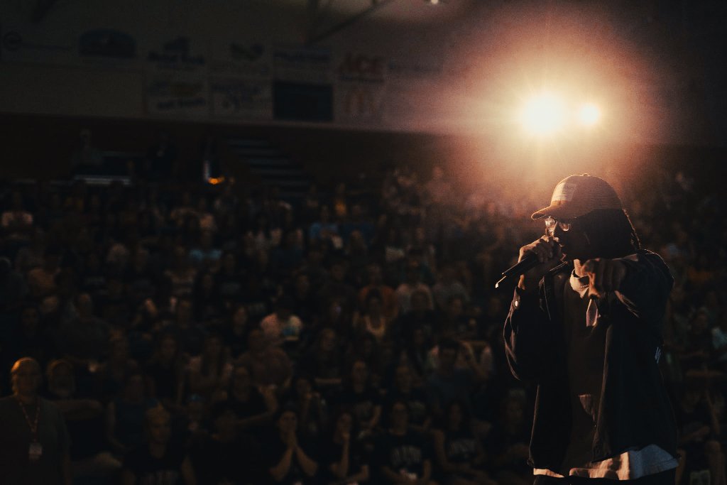 Soul Hemingway speaking on stage with rim lighting