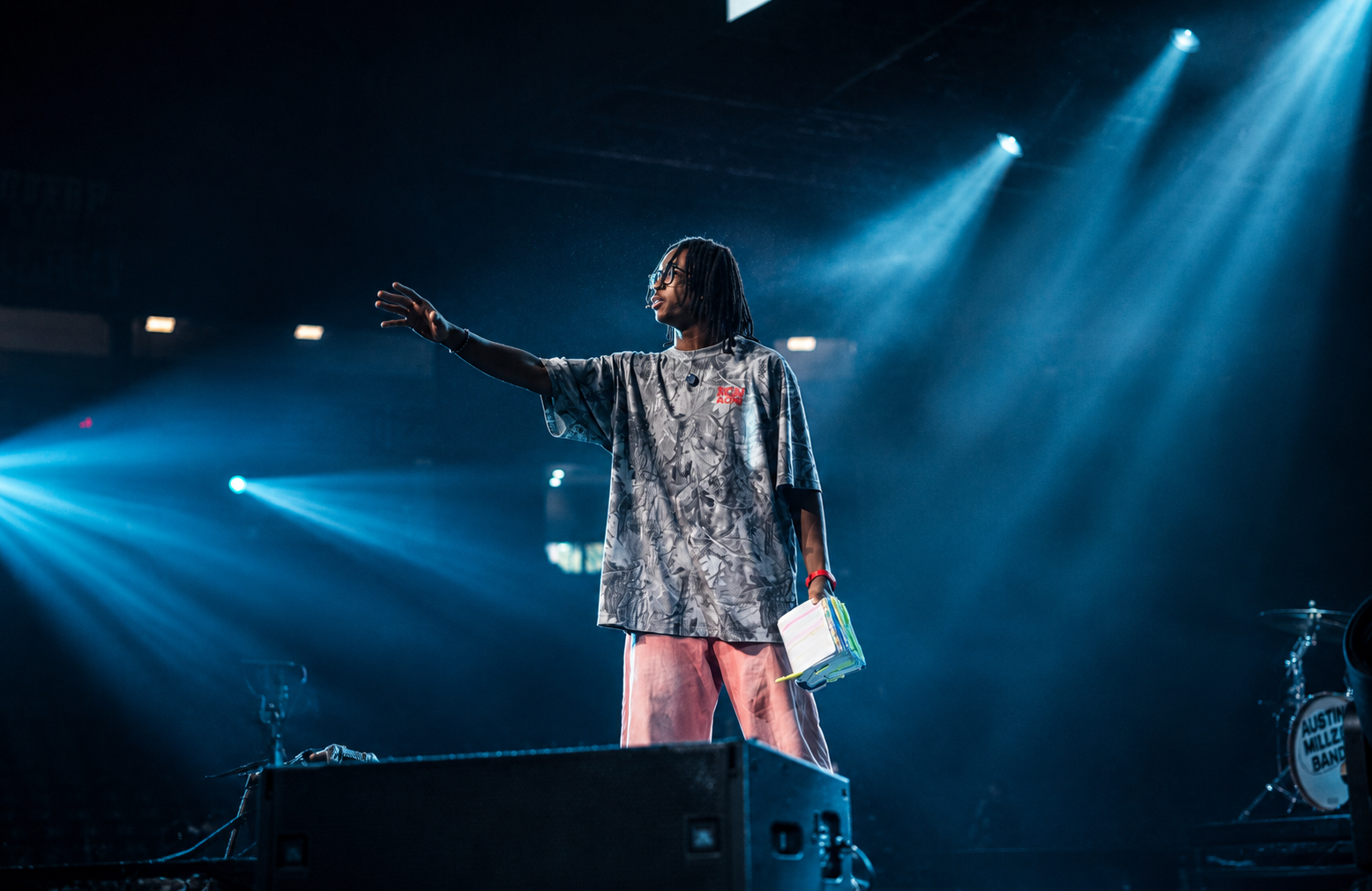 Soul Hemingway preaching on stage under blue stage spotlights