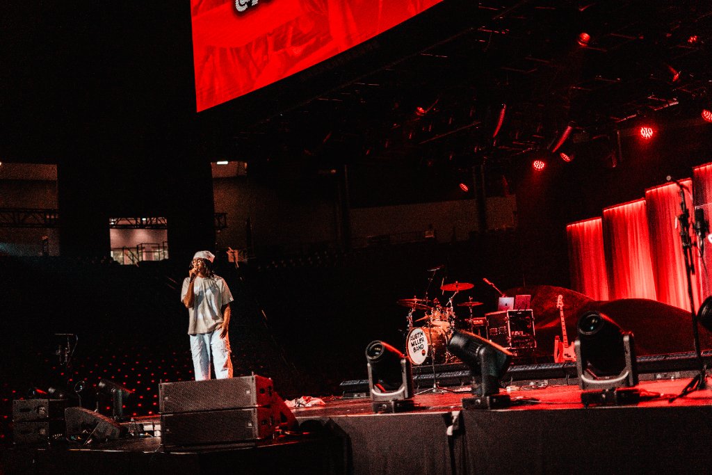 Soul Hemingway performing on stage with red lighting at the Vines Center