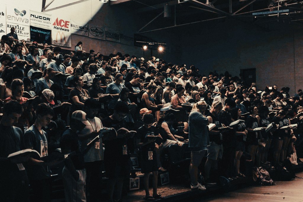 Wide view of camp crowd seated in bleachers