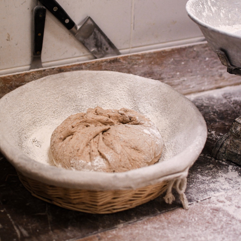 Sourdough dough proofing in a banneton basket