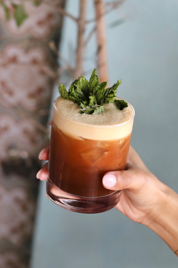 Iced coffee with foam and mint