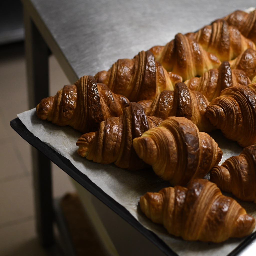 Fresh croissants on a baking tray