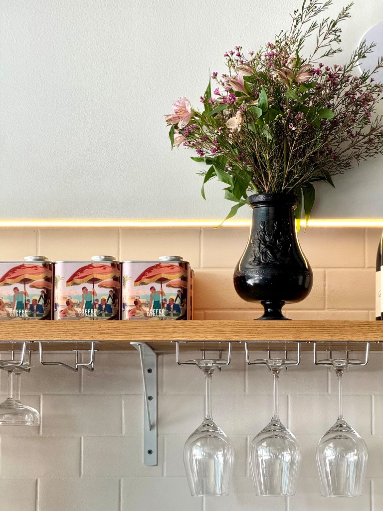 Shelf with coffee tins and flowers
