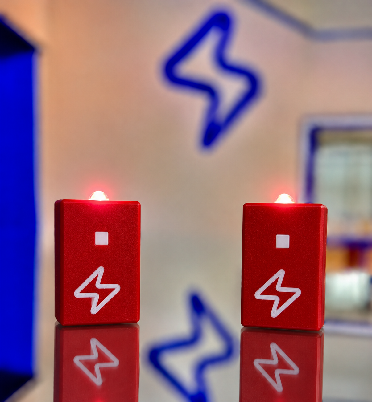 Mini Zap Light — a red plastic STEM build kit with a glowing LED, built by kids at ZapLab in Spokane
