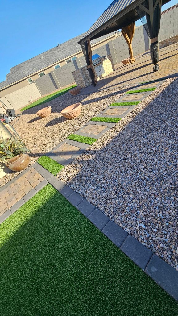 Desert landscape with turf, pavers, and gazebo